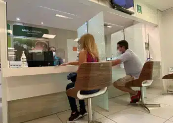 Atendentes da Unimed em balcão de atendimento a pacientes.