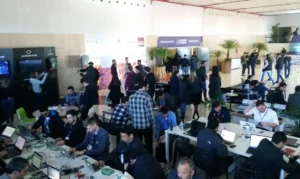  Evento de tecnologia e startups com participantes trabalhando em laptops e networking.