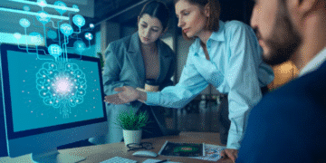 Profissionais analisando dados em tela com inteligência artificial no ambiente de trabalho.