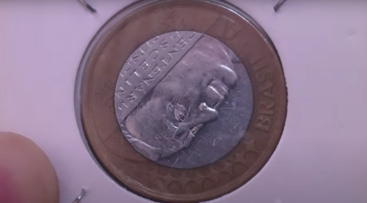 Moeda de 1 real com a face de Juscelino Kubitschek e erro de reverso invertido