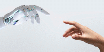 Mão de robô futurista se aproximando da mão de uma pessoa, simbolizando a interação entre humanos e inteligência artificial