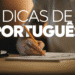Pessoa escrevendo em caderno com lápis, ao fundo a frase “Dicas de Português” em destaque