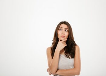 Mulher pensativa, simbolizando a dúvida sobre o uso correto das formas ‘sido’ ou ‘cido’ na língua portuguesa.