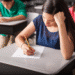 Estudantes fazendo prova em sala de aula.