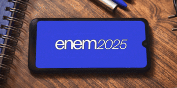 Smartphone exibindo o texto "Enem2025" em tela azul sobre mesa de madeira com caderno, canetas e plugue.