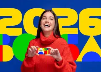 Mulher jovem sorrindo, vestindo suéter vermelho, segurando cartão do programa Família 2026 com fundo colorido e texto grande