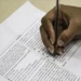 Pessoa preenchendo prova do Encceja, relacionada à divulgação do resultado de 2025.