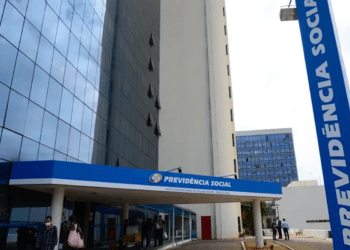 Fachada do edifício sede da Previdência Social com letreiro azul e pessoas circulando na entrada
