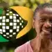 Imagem de uma mulher sorrindo, com um fundo desfocado e o logo de uma organização ao lado, ilustrando o tema sobre as novas regras de aposentadoria para mulheres em 2026.