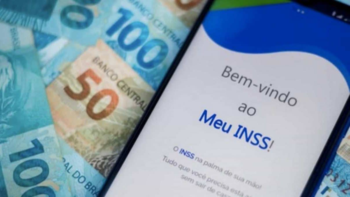 Tela de boas-vindas ao aplicativo Meu INSS exibindo cédulas de reais.