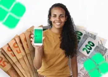 Mulher segurando celular com PIX e notas de dinheiro representando consulta de valores esquecidos em bancos para recebimento em 2026