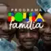 Pai, mãe e filho sorrindo juntos com notas de 100 reais e logo do Bolsa Família à frente